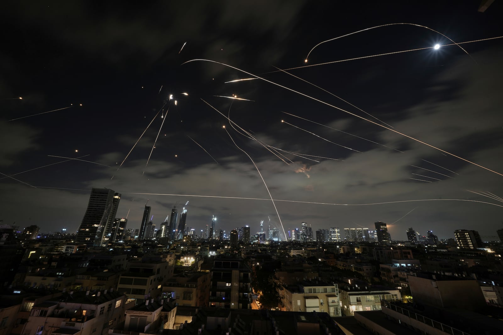 The Israeli Iron Dome air defense system fires to intercept missiles during an Iranian attack over Tel Aviv, Israel, Sunday, June 15, 2025. (AP Photo/Leo Correa)
