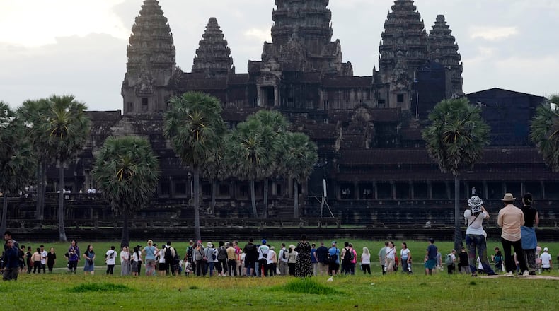FILE - Tourists wait for sunrise at the Angkor Wat temple in Siem Reap province, Cambodia, Friday, Aug. 2, 2024. (AP Photo/Heng Sinith, File)