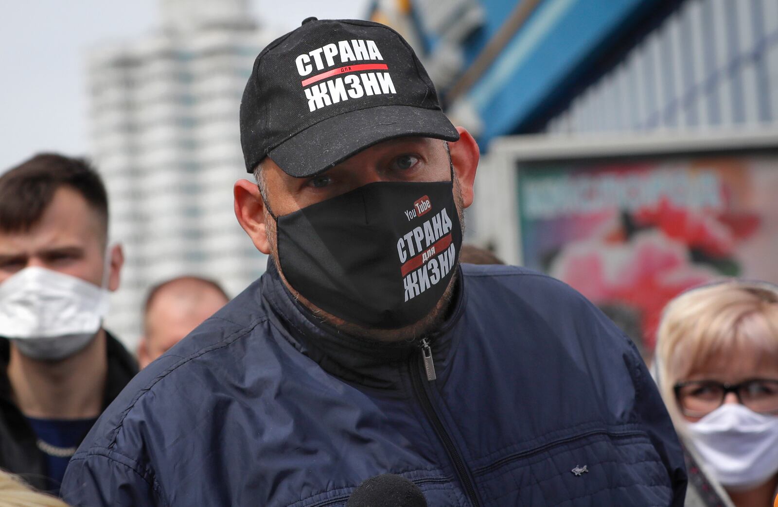 FILE - Blogger Siarhei Tsikhanouski, wearing a face mask to protect against coronavirus, speaks to people gathered to sign up and support potential presidential candidates in the upcoming presidential elections in Minsk, Belarus, Sunday, May 24, 2020. (AP Photo, File)