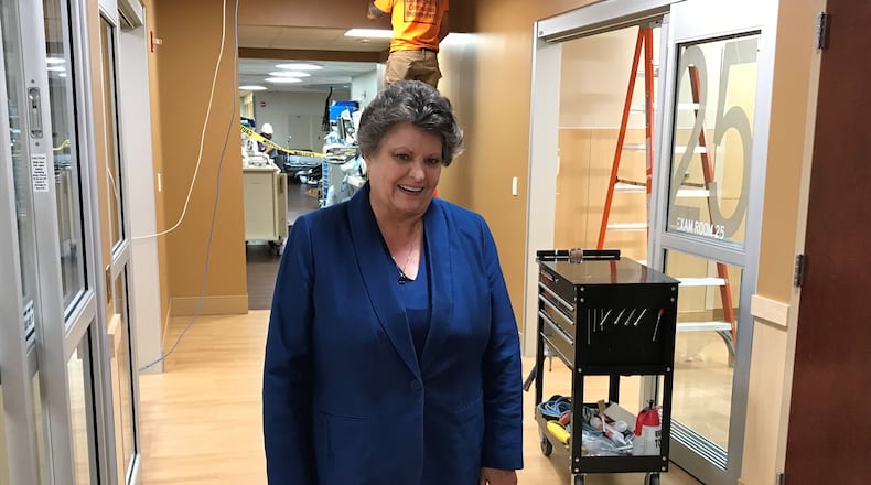 Grandview Medical Center president Becky Lewis stands in the emergency room at the Dayton hospital where construction workers are adding new patient rooms.