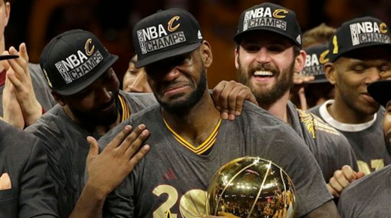 Cleveland Cavaliers forward LeBron James, center, celebrates with teammates after Game 7 of basketball's NBA Finals against the Golden State Warriors in Oakland, Calif., Sunday, June 19, 2016. The Cavaliers won 93-89. (AP Photo/Marcio Jose Sanchez)