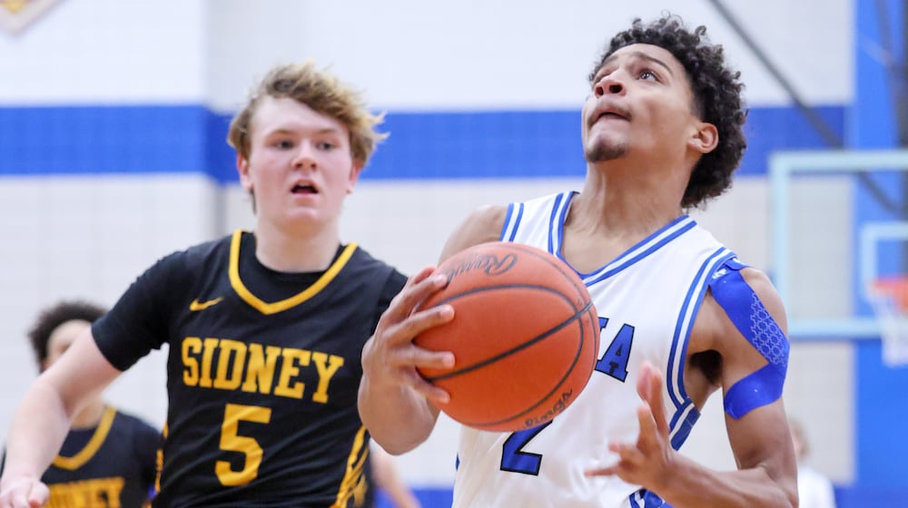 Xenia junior guard Devin Withers drives with pressure from Sidney's Connor Widmark during the second half of a Miami Valley League game on Thursday at Phil Anderson Gymnasium in Xenia. Withers led the Buccaneers with 30 points in an 84-70 win. BRYANT BILLING/STAFF