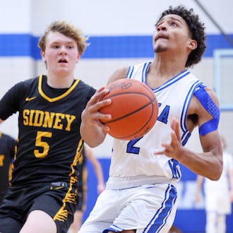 Xenia junior guard Devin Withers drives with pressure from Sidney's Connor Widmark during the second half of a Miami Valley League game on Thursday at Phil Anderson Gymnasium in Xenia. Withers led the Buccaneers with 30 points in an 84-70 win. BRYANT BILLING/STAFF