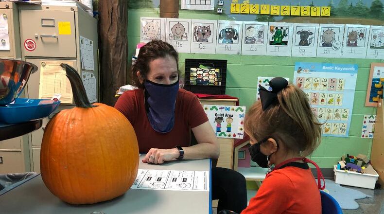 Jill Wuebker, a preschool teacher at Clark Early Learning Center in Springfield, works with student Juniper Schneider. Being back with her students is helping Wuebker overcome her bout with breast cancer, which she discovered last winter. BRETT TURNER/CONTRIBUTED
