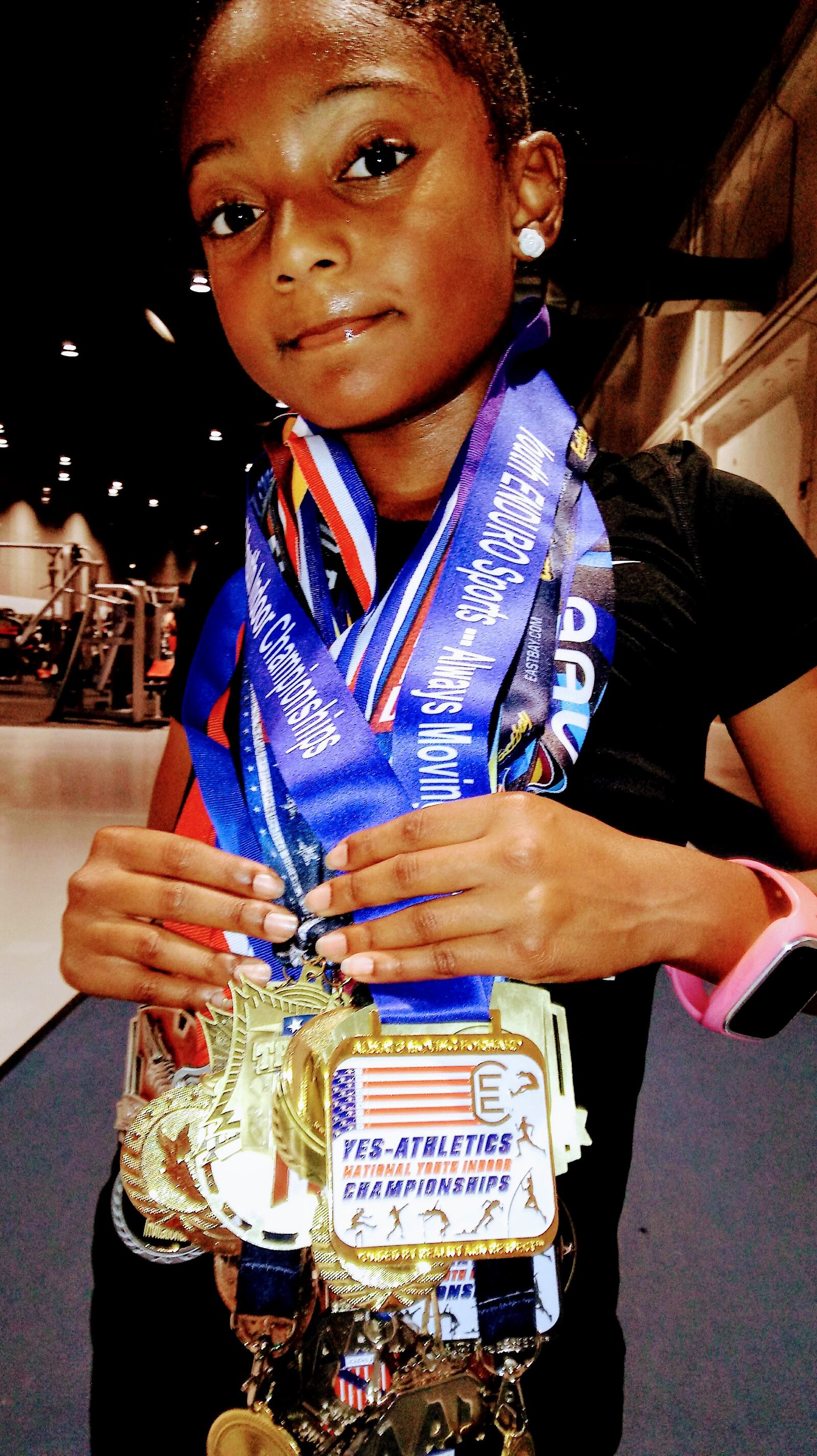 13 year old Jaiya with a few of the medals she has won in 400 meter races across the nation over the years.