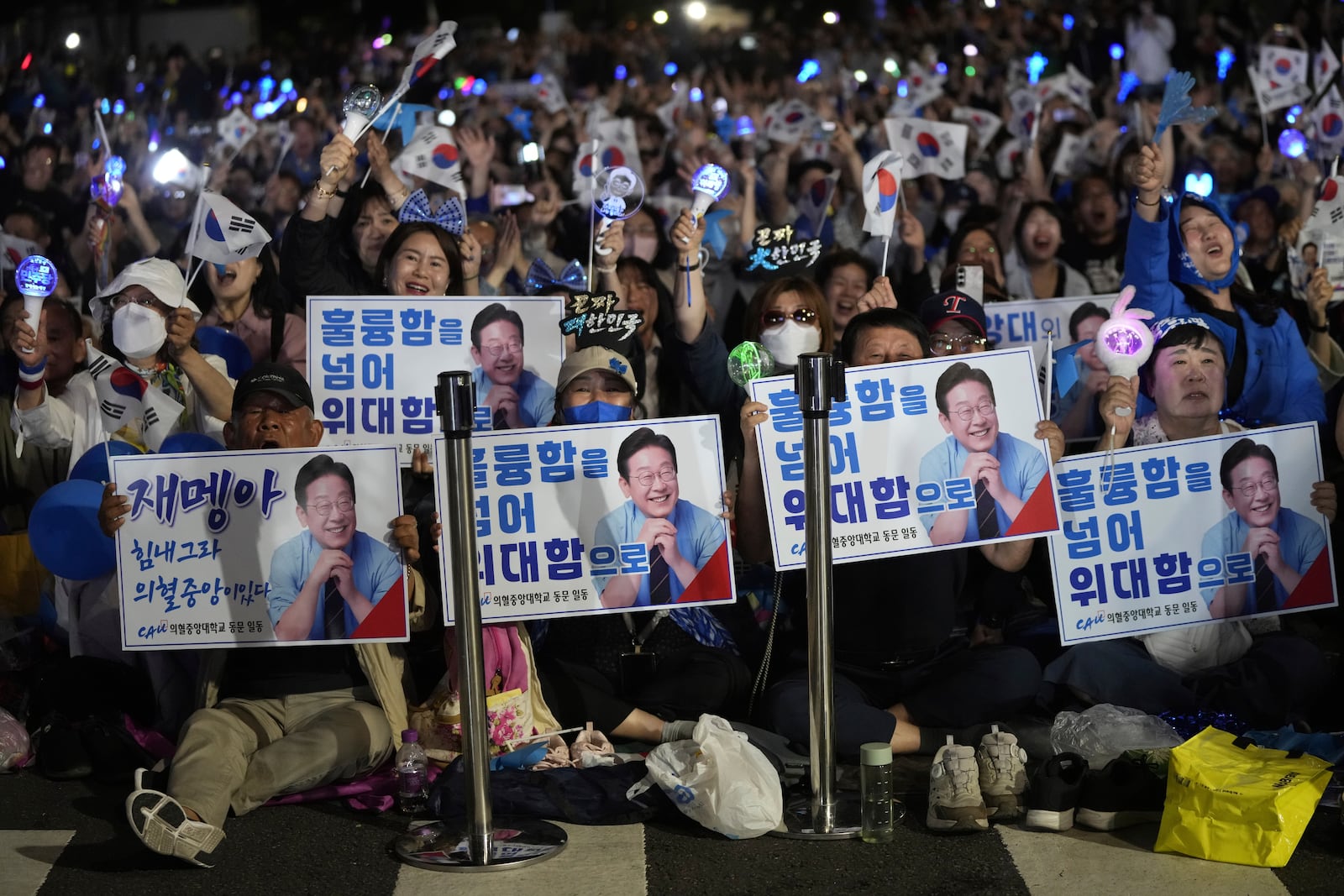 Supporters of South Korea's Democratic Party's presidential candidate Lee Jae-myung, react outside the National Assembly in Seoul, South Korea, Tuesday, June 3, 2025. (AP Photo/Ahn Young-joon)