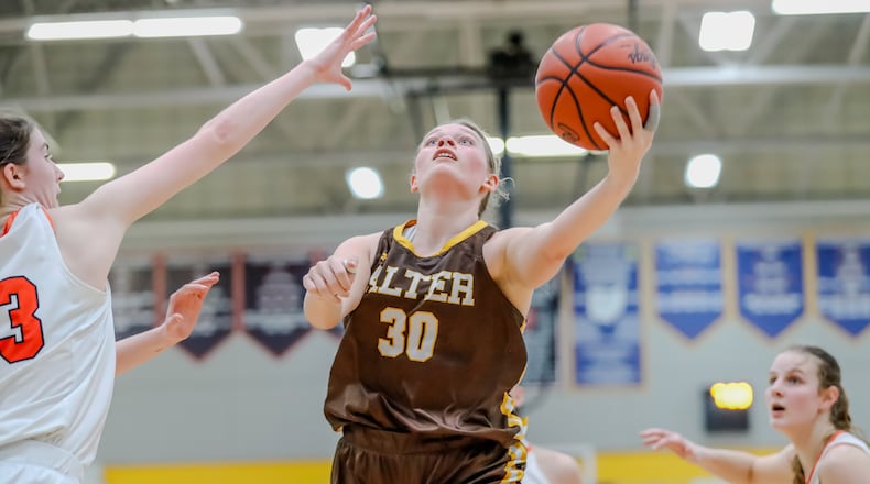 Alter High School junior Maddie Moody drives to the hoop during their Division III regional semifinal game against Versailles on Wednesday night at Springfield High School. The Knights won 63-40. Michael Cooper/CONTRIBUTED