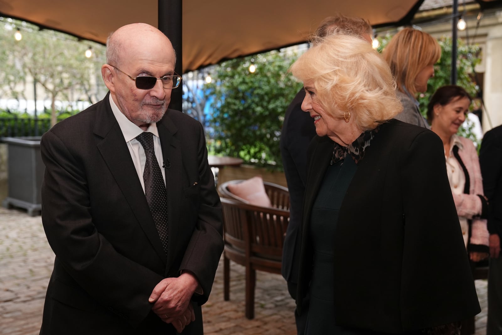 Author Salman Rushdie, left, meets Queen Camilla at the 2025 Cliveden Literary Festival, in Cliveden, England, Saturday, Oct. 11, 2025. (Jacob King/Pool Photo via AP)
