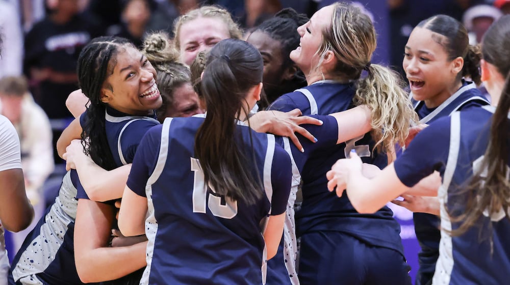 Fairmont senior guard Kaylah Thornton is mobbed by teammates during a celebration following the Firebirds' 61-55 victory over Princeton in the Division I state final on Saturday, March 14 at University of Dayton Arena. Thornton scored 19 points, including the game-tying 3 to send it to overtime. BRYANT BILLING / STAFF