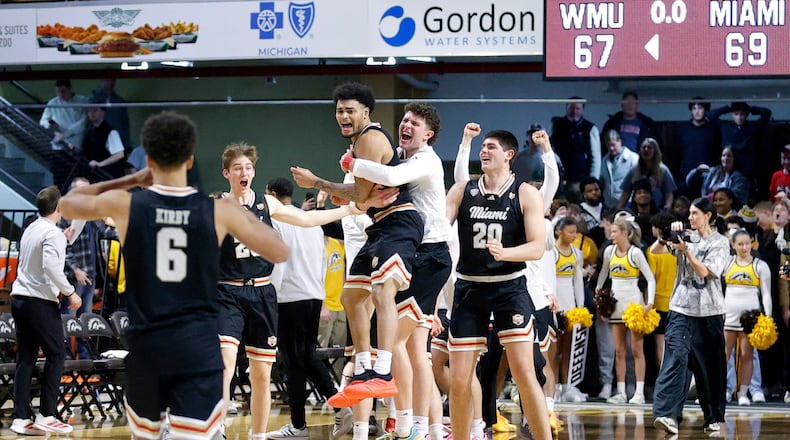Miami (Ohio) players, including guard Trey Perry, center left, celebrate after Perry hit the game-winning shot against Western Michigan during the second half of an NCAA college basketball game, Friday, Feb. 27, 2026, in Kalamazoo, Mich. (AP Photo/Al Goldis)