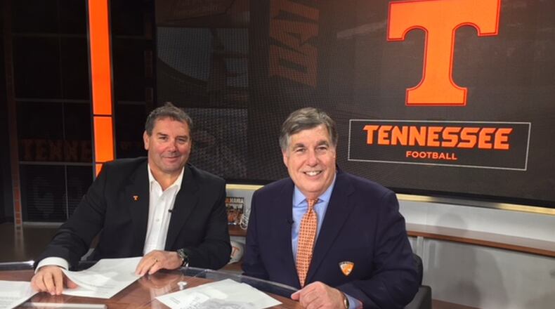 Brady Hoke (left) and Bob Kesling huddle together for the weekly University of Tennessee football call-in radio show Big Orange Hotline prior to the LSU game, the first of two contests that Hoke served as the Vols’ interim head coach during the 2017 season. CONTRIBUTED PHOTO