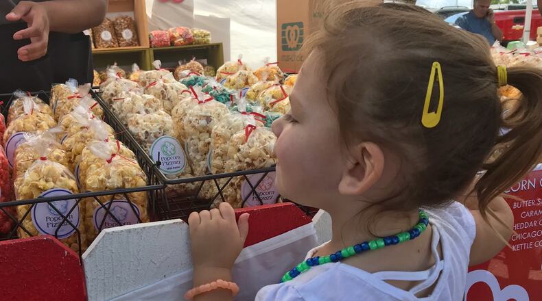 Festivalgoers were not afraid to get their hands sticky as flavored popcorn of every variety filled Dayton-Xenia Road for the 33rd Beavercreek Popcorn Festival on Saturday and Sunday, Sept. 7 & 8, 2019. SARAH FRANKS/STAFF