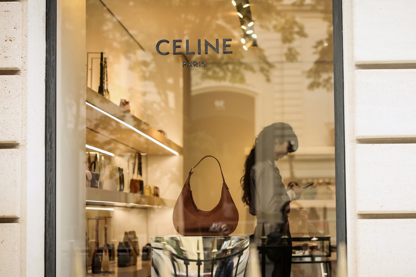A woman works in a Celine shop, Monday, July 28, 2025 in Paris. (AP Photo/Thomas Padilla)