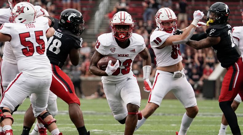 Miami (Ohio) running back Kenny Tracy (33) scores a touchdown during the second half of an NCAA college football game against Cincinnati, Saturday, Sept. 4, 2021, in Cincinnati. (AP Photo/Jeff Dean)