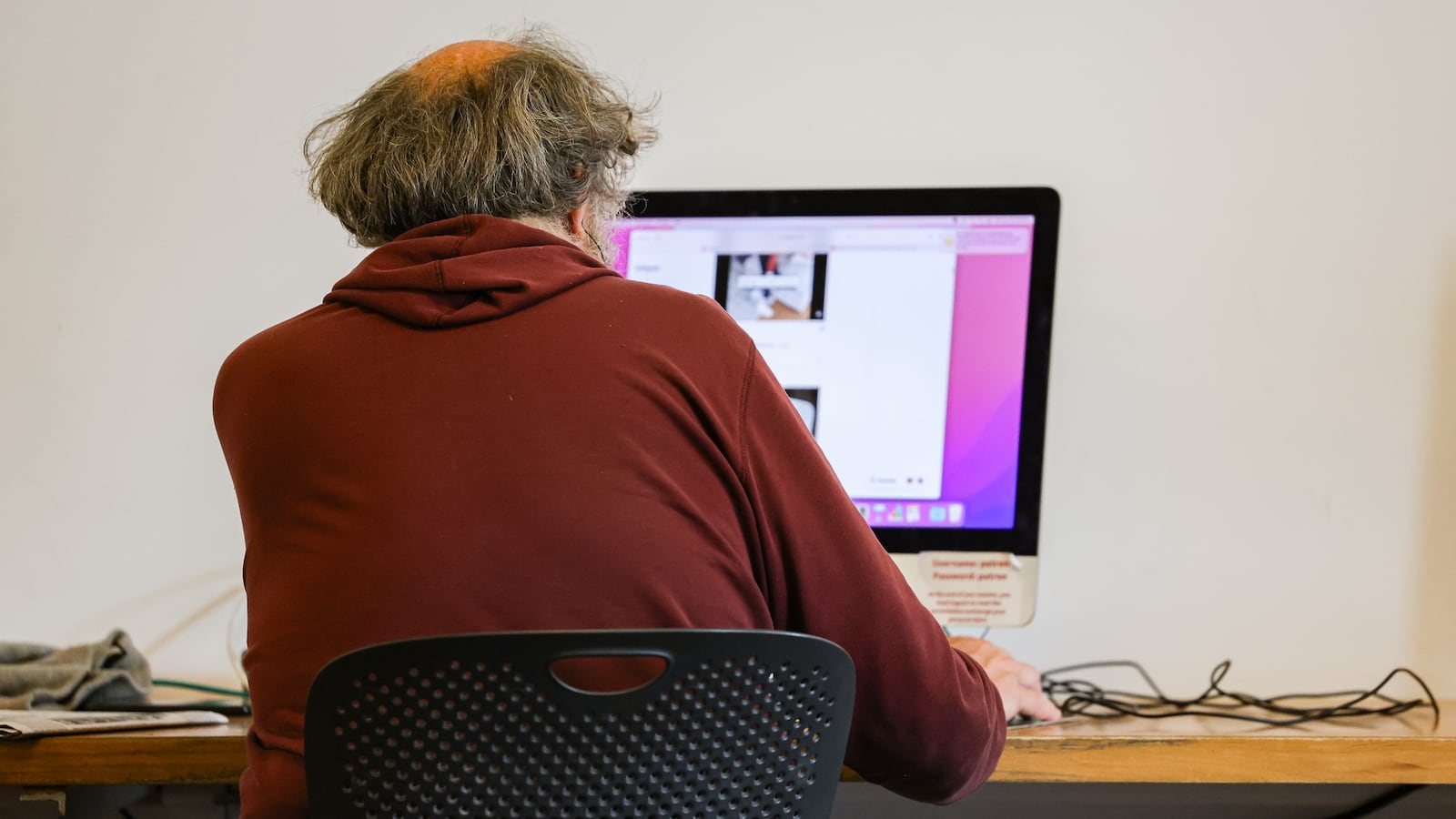 A man uses a computer at Dayton Metro Library's main branch on Wednesday, June 25. Many of these cybercriminals operate themselves as commercial enterprises, highly organized with specific processes and operations, according to JP Castellanos, director of threat intelligence at Binary Defense, a cybersecurity company in northeast Ohio. BRYANT BILLING / STAFF