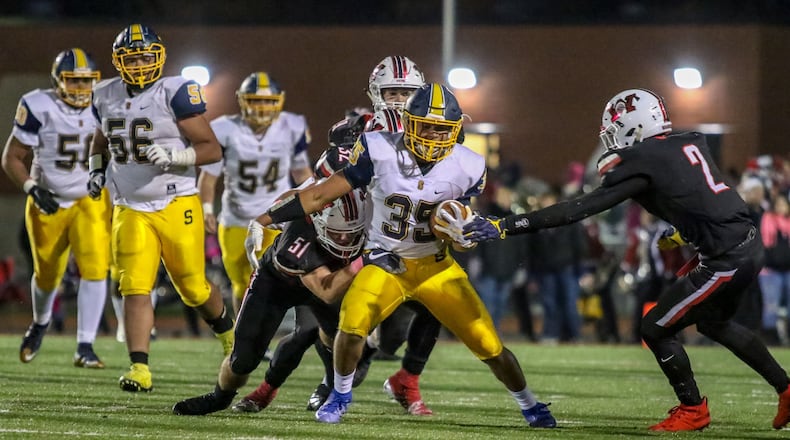 Springfield High School’s Jeff Tolliver runs through multiple Wayne defenders during their game on Friday night at Heidkamp Stadium. The Wildcats won 38-13. CONTRIBUTED PHOTO BY MICHAEL COOPER