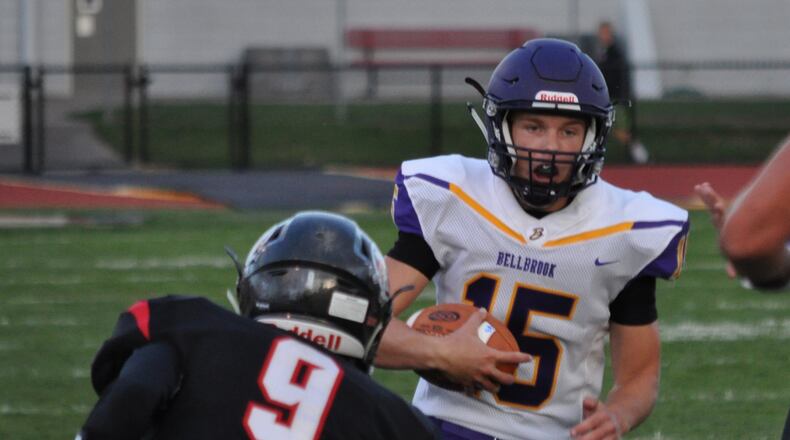 Bellbrook junior quarterback Brendan Labensky looks downfield while Tecumseh’s Blais Hale waits to deliver a hit Thursday Sept. 7, 2017, at Spitzer Stadium Sept. 7, 2017. Nick Dudukovich/Contributed