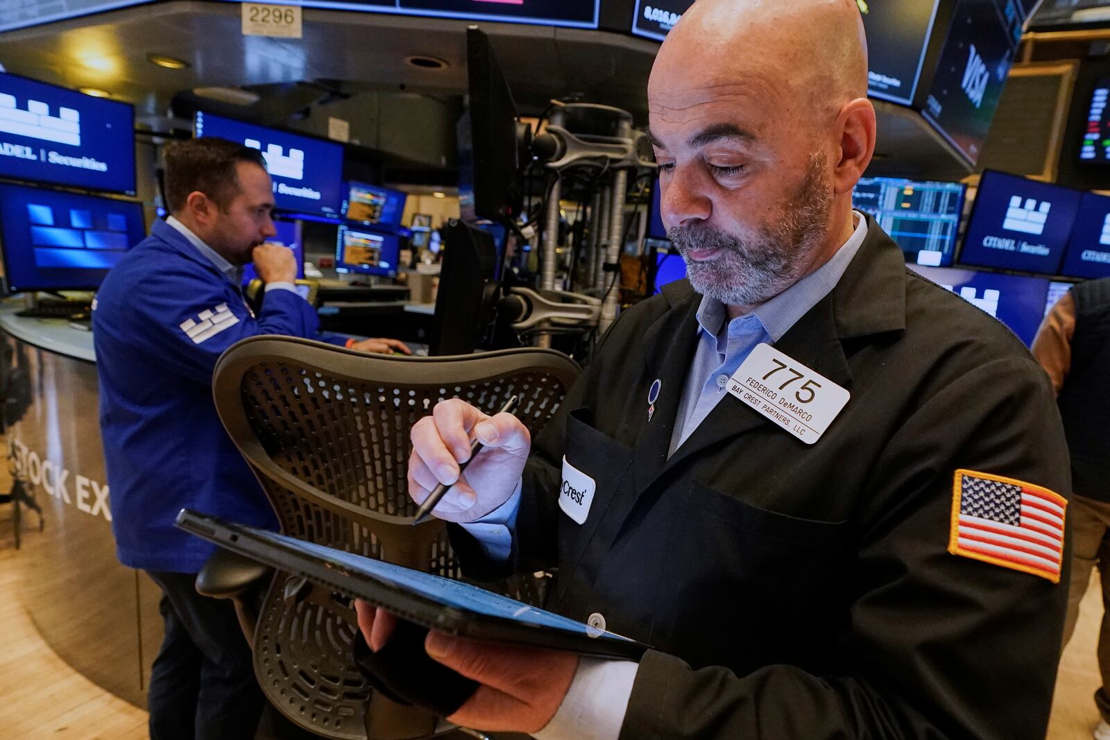 Trader Fred Demarco, right, works on the floor of the New York Stock Exchange, Thursday, April 10, 2025. (AP Photo/Richard Drew)
