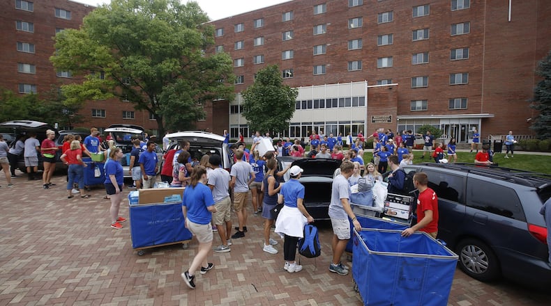Scene from move in day 2018 at the University of Dayton. Junior Cordell Stover directs traffic at Marycrest Hall. TY GREENLEES / STAFF