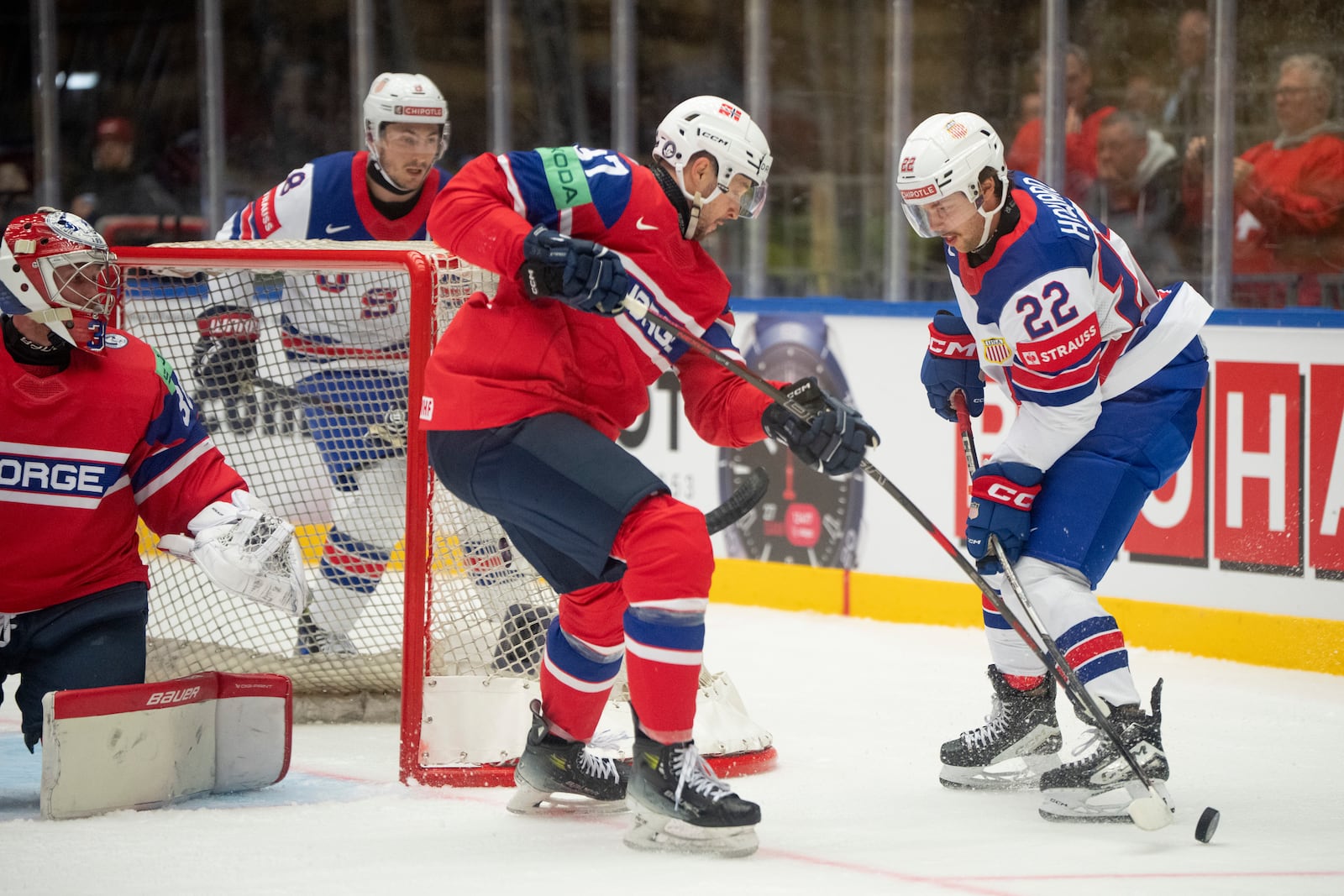 USA's Isaac Howard, right, and Norway's Markus Vikingstad, second right, challenge for the puck during the group B match between USA and Norway at the IIHF Ice Hockey World Championships in Herning, Denmark, Wednesday, May 14, 2025. (Bo Amstrup/Ritzau Scanpix via AP)