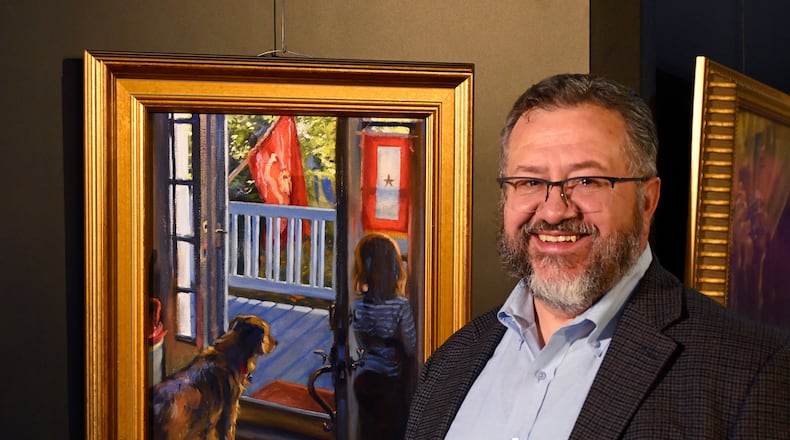 Combat artist Charles Grow stands before his painting “Missing Him.” He created the painting in memory of his son-in-law. CONTRIBUTED