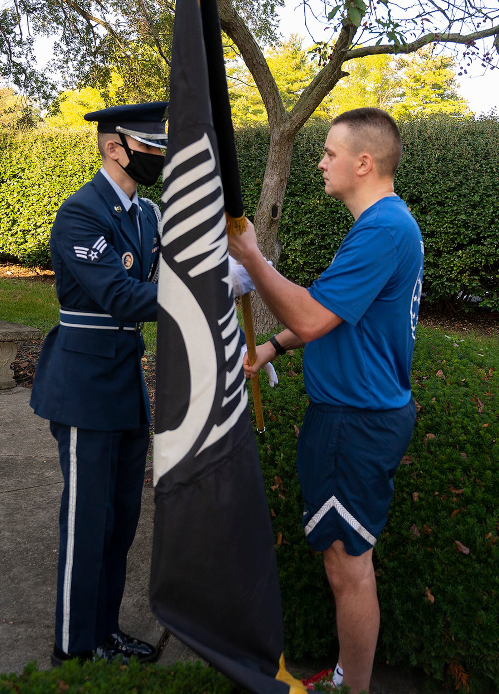 Chief Master Sgt. Chris Sutor, National Air and Space Intelligence Center, hands the POW/MIA Flag to an Honor Guard Airman during the POW/MIA Recognition Day wreath-laying ceremony Sept. 17 at Wright-Patterson Air Force Base. U.S. AIR FORCE PHOTO/R.J. ORIEZ