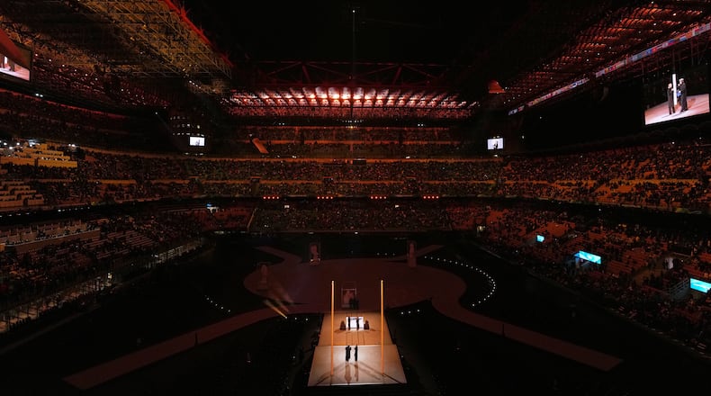 Spectators watch a pre-show ahead of the Olympic opening ceremony at the 2026 Winter Olympics, in Milan, Italy, Friday, Feb. 6, 2026. (AP Photo/Carolyn Kaster)