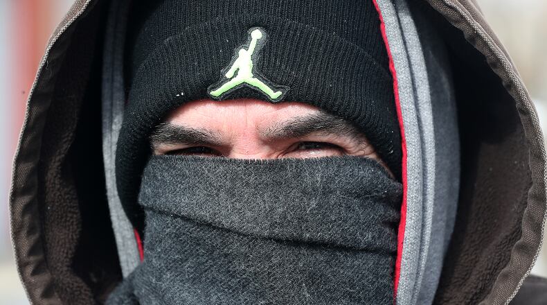 Billy May was bundled up against the cold Tuesday as he walk down the street in downtown Springfield Tuesday. BILL LACKEY/STAFF