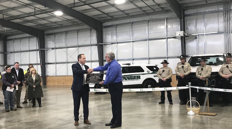 Brentwood Builders of Centerville, BlueScope Construction out of Kansas City, Greene Co. Parks & Trails director Jon Dobney, Greene. Co. Park Rangers and other project leaders cut the ribbon on the new home of the Greene Co. Parks & Trails building on Wednesday, December 18, 2019. STAFF PHOTO / SARAH FRANKS