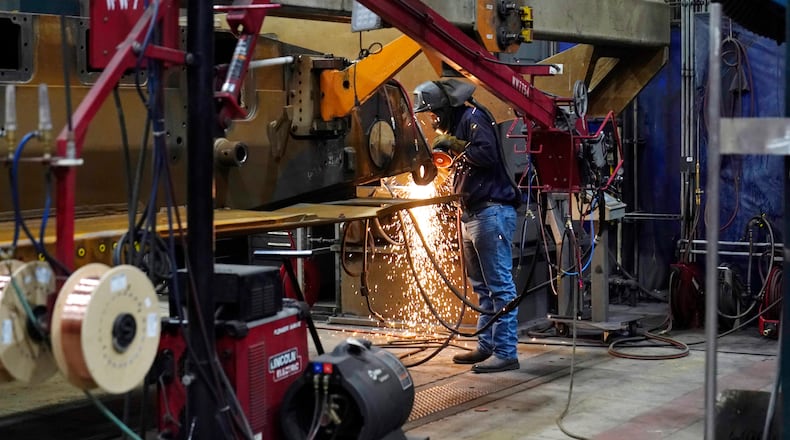 A worker grinds a weld on the latest version of the M1A2 Abrams main battle tank being built at the Joint Systems Manufacturing Center, Thursday, Feb. 16, 2023, in Lima, Ohio. (AP Photo/Carlos Osorio)