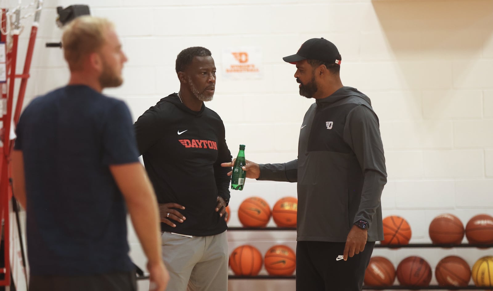 Dayton's Anthony Grant, center, talks to Ricardo Greer during practice at the Cronin Center on Wednesday, Oct. 8, 2025. David Jablonski/Staff