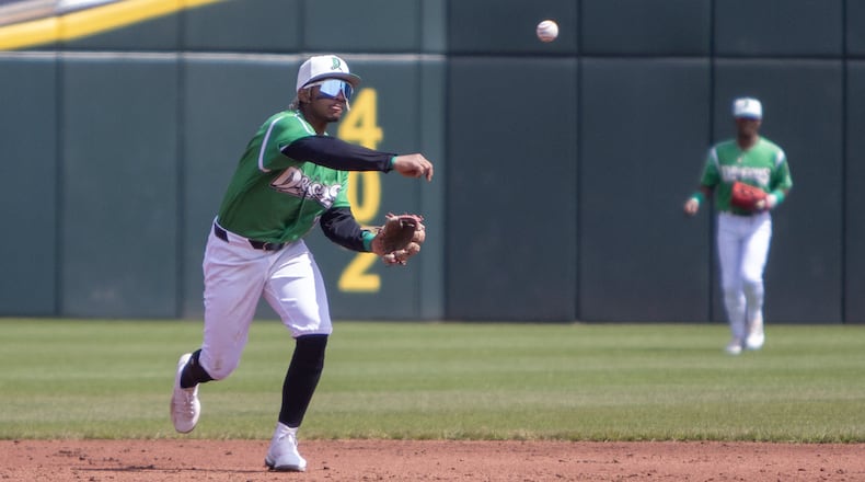 Dragons shortstop Victor Acosta throws out to first for an out on a grounder by Fort Wayne's Braedon Karpathios during Sunday's game at Day Air Ballpark. Jeff Gilbert/CONTRIBUTED