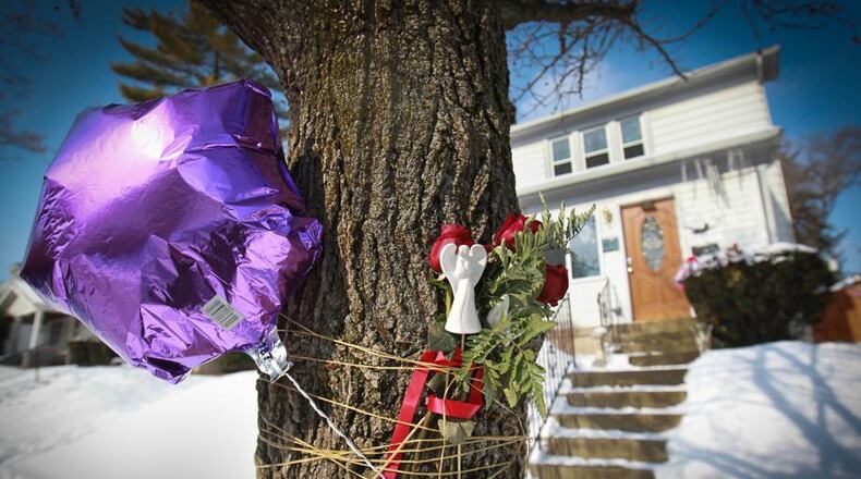 Balloons, flowers and other items were placed in front of Klonda Richey’s home, 31 E. Bruce Ave., in Dayton where she was mauled to death in 2014 by a neighbor’s dogs. FILE