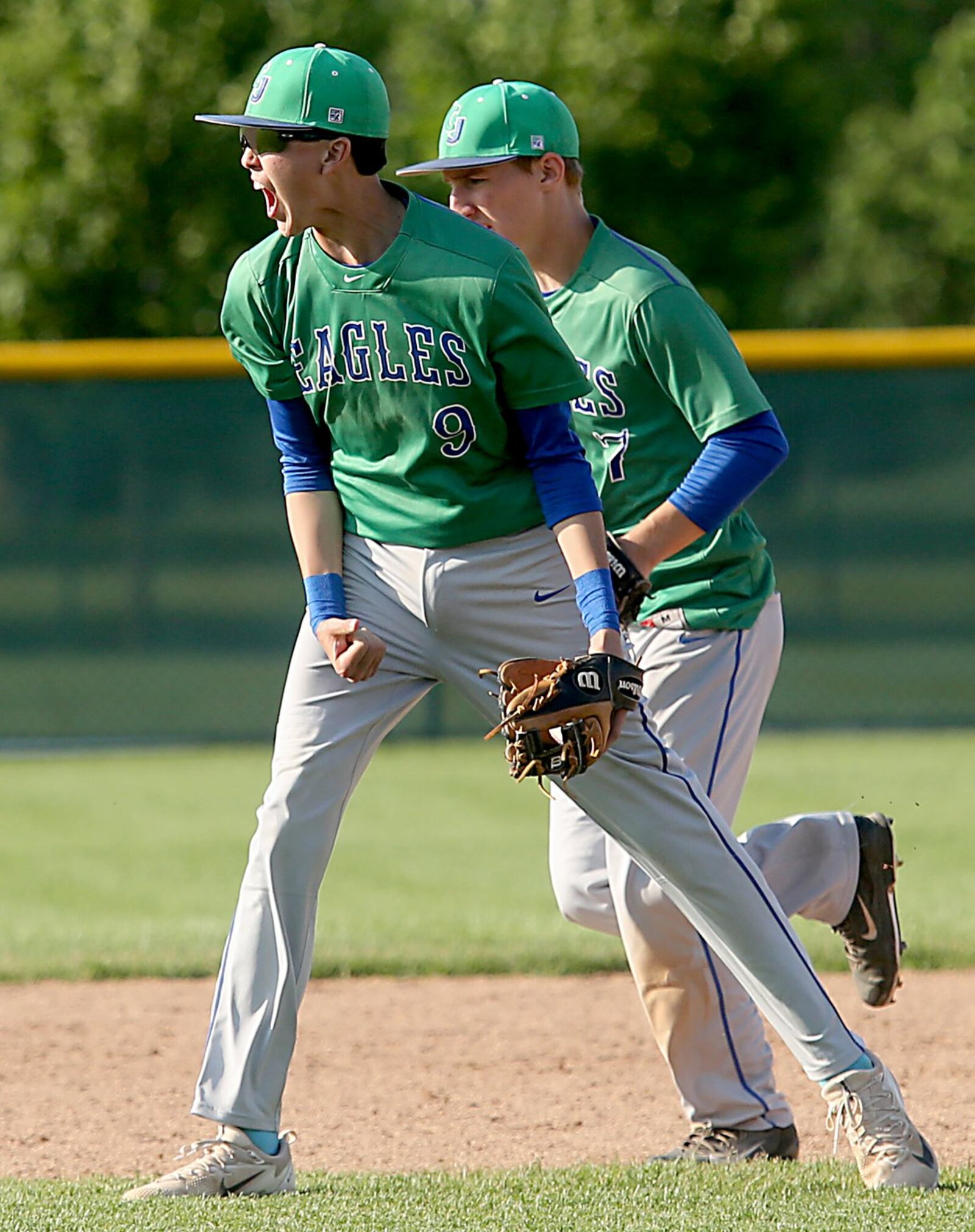 Chaminade Julienne’s Nick Wissman reacts after getting the final out as he and teammate Mark Barhorst run off the field at the end of their Division II regional semifinal victory over Waynesville at Mason. CONTRIBUTED PHOTO BY E.L. HUBBARD