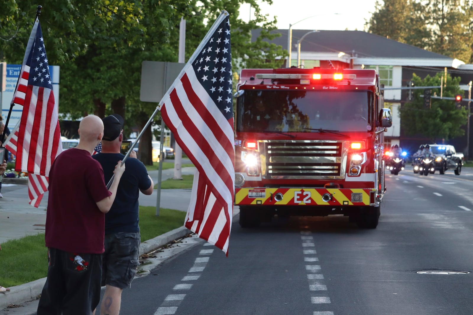 A procession from Kootenai Health headed to Spokane after a few firefighters were killed Sunday, June 29, 2025, when they were ambushed by sniper fire while responding to a blaze in a northern Idaho mountain community, in Coeur d’Alene, Idaho. (Bill Buley/Coeur D'Alene Press via AP)