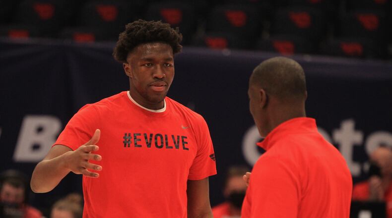 Dayton's Jordy Tshimanga greets coach Anthony Grant during a Senior Night ceremony before a game against Saint Louis on Senior Night on Friday, Feb. 19, 2021, at UD Arena. David Jablonski/Staff