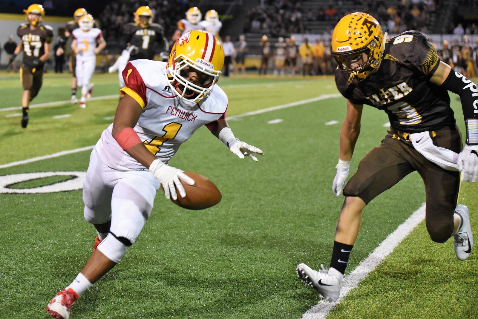 Fenwick’s Jordan Rucker (1) is pursued by Alter’s Derek Willits (9) on Friday night at Centerville Stadium in a game won by Alter 45-20. CONTRIBUTED PHOTO BY ANGIE MOHRHAUS