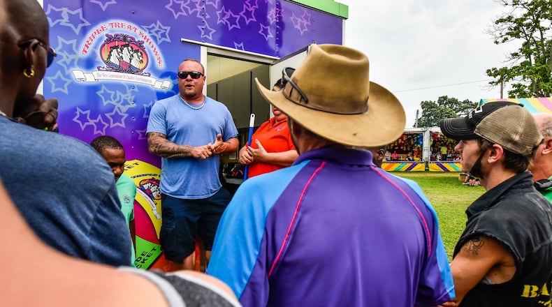 Russell Clements, manager for Triple Treat Shows, speaks to ride workers in their morning safety meeting at the Butler County Fair Thursday, July 27, at Butler County Fairgrounds in Hamilton. NICK GRAHAM/STAFF