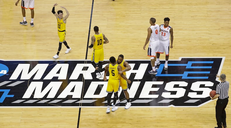 FILE - UMBC players celebrate their 74-54 win over Virginia in a first-round game in the NCAA men's college basketball tournament in Charlotte, N.C., March 16, 2018. Five years ago Thursday a tiny school few had ever heard of — and virtually no one gave an ounce of a chance to win — pulled off the biggest upset in NCAA Tournament history as University of Maryland-Baltimore County knocked off the tournament’s top overall seed, elevating March Madness to a whole new level. (AP Photo/Chuck Burton, File)