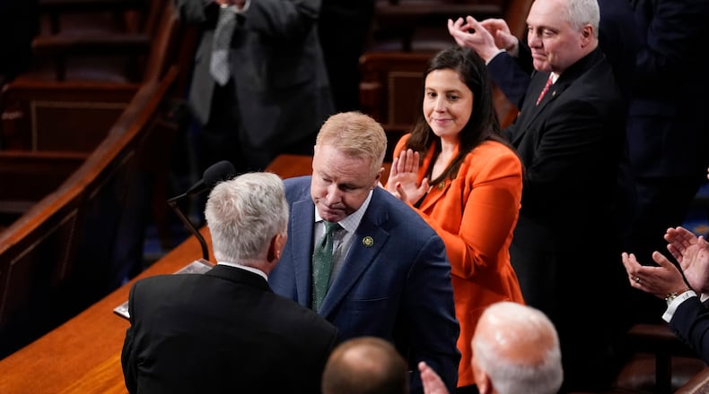 Rep. Warren Davidson, R-Ohio, shakes hands with Rep. Kevin McCarthy, R-Calif., after nominating him for speaker in the fifth rounding of voting in the House chamber as the House meets for a second day to elect a speaker and convene the 118th Congress in Washington, Wednesday, Jan. 4, 2023. Watching are Rep. Elise Stefanik, R-N.Y., and Rep. Steve Scalise, R-La. (AP Photo/Andrew Harnik)