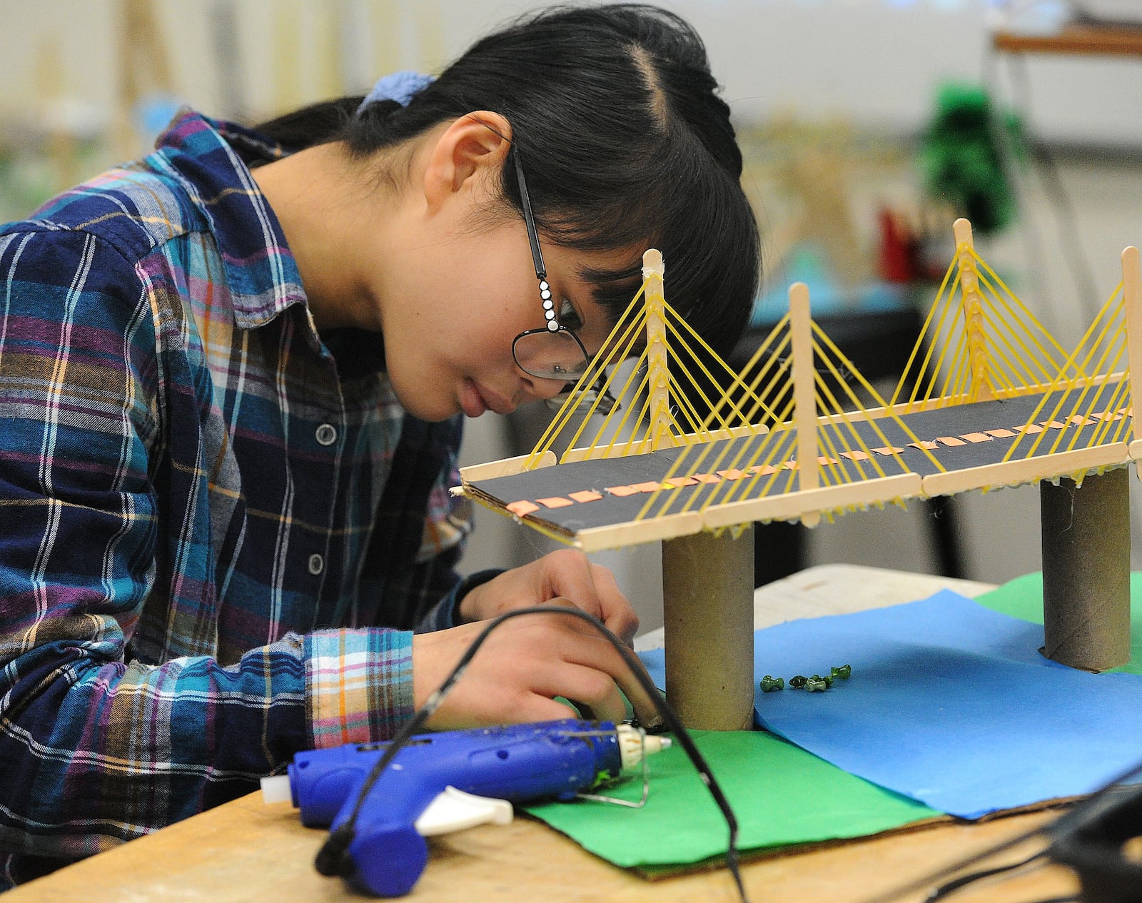 Dayton Regional STEM school student, Katarina England, works on her spaghetti noodle bridge in class Wednesday, March 6, 2024. MARSHALL GORBY\STAFF