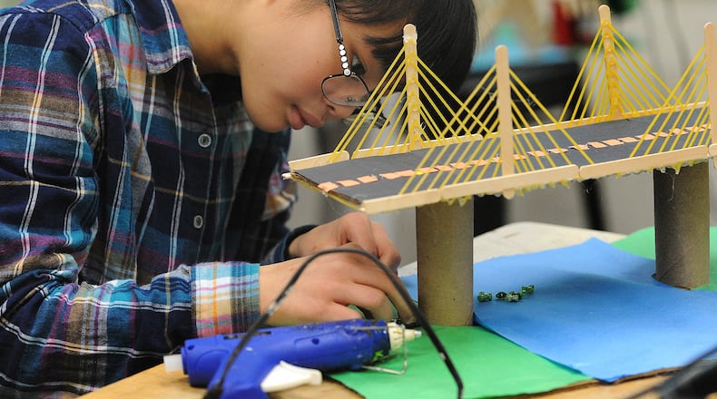 Dayton Regional STEM school student, Katarina England, works on her spaghetti noodle bridge in class Wednesday, March 6, 2024. MARSHALL GORBY\STAFF