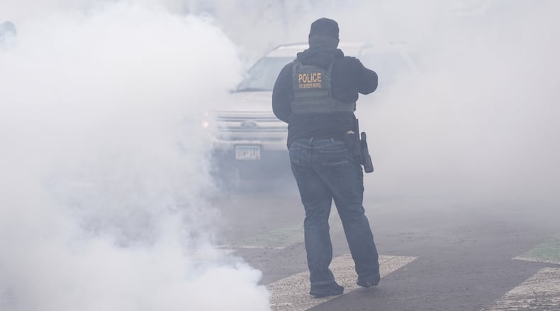 Tear gas is deployed as Federal agents make arrests on Wednesday, Jan. 21, 2026, in Minneapolis. (AP Photo/Angelina Katsanis)