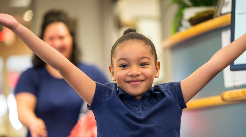 A child celebrates as she leaves the Wright-Field South Child Development Center on April 29 at Wright-Patterson Air Force Base. U.S. AIR FORCE PHOTO/JAIMA FOGG