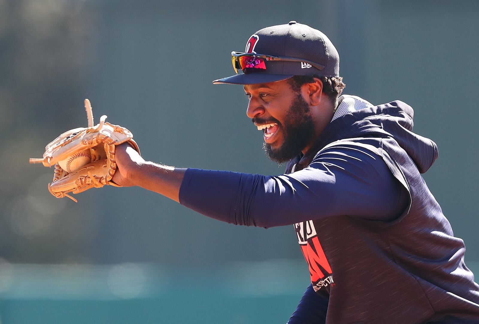 Recently acquired Braves second baseman Brandon Phillips is all smiles fielding a grounder on his first day at spring training Friday. (Curtis Compton/ccompton@ajc.com)