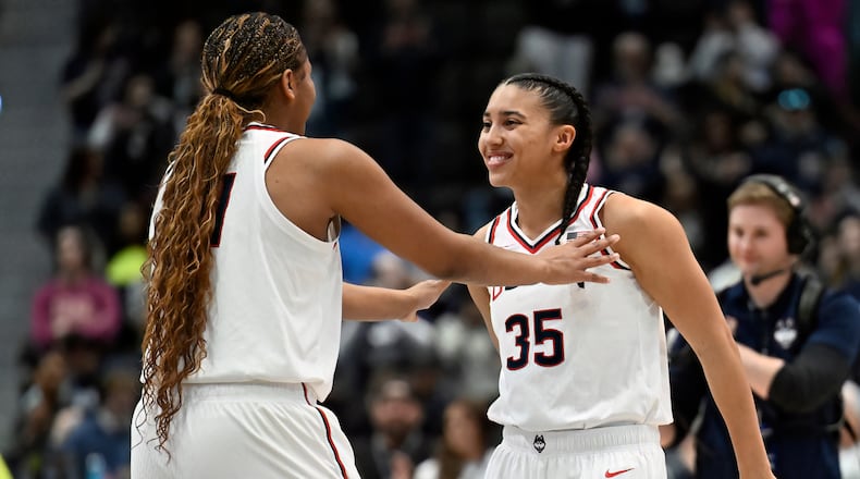UConn forward Sarah Strong, left, talks with UConn guard Azzi Fudd, right, before tip off in an NCAA college basketball game against Georgetown, Thursday, Feb. 26, 2026, in Hartford, Conn. (AP Photo/Jessica Hill)