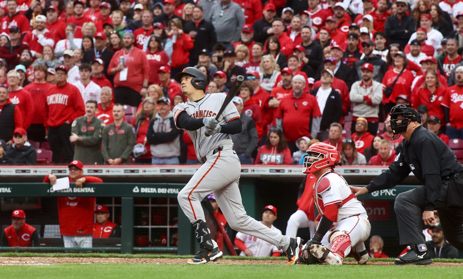 Wilmer Flores, of the Giants, hits a tie-breaking, three-run home run against the Reds in the ninth inning on Thursday, March 27, 2025, on Opening Day at Great American Ball Park in Cincinnati. David Jablonski/Staff