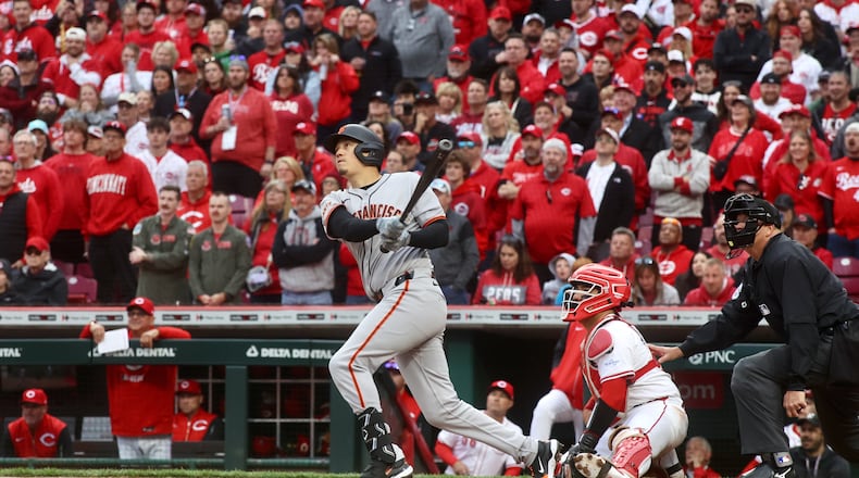 Wilmer Flores, of the Giants, hits a tie-breaking, three-run home run against the Reds in the ninth inning on Thursday, March 27, 2025, on Opening Day at Great American Ball Park in Cincinnati. David Jablonski/Staff