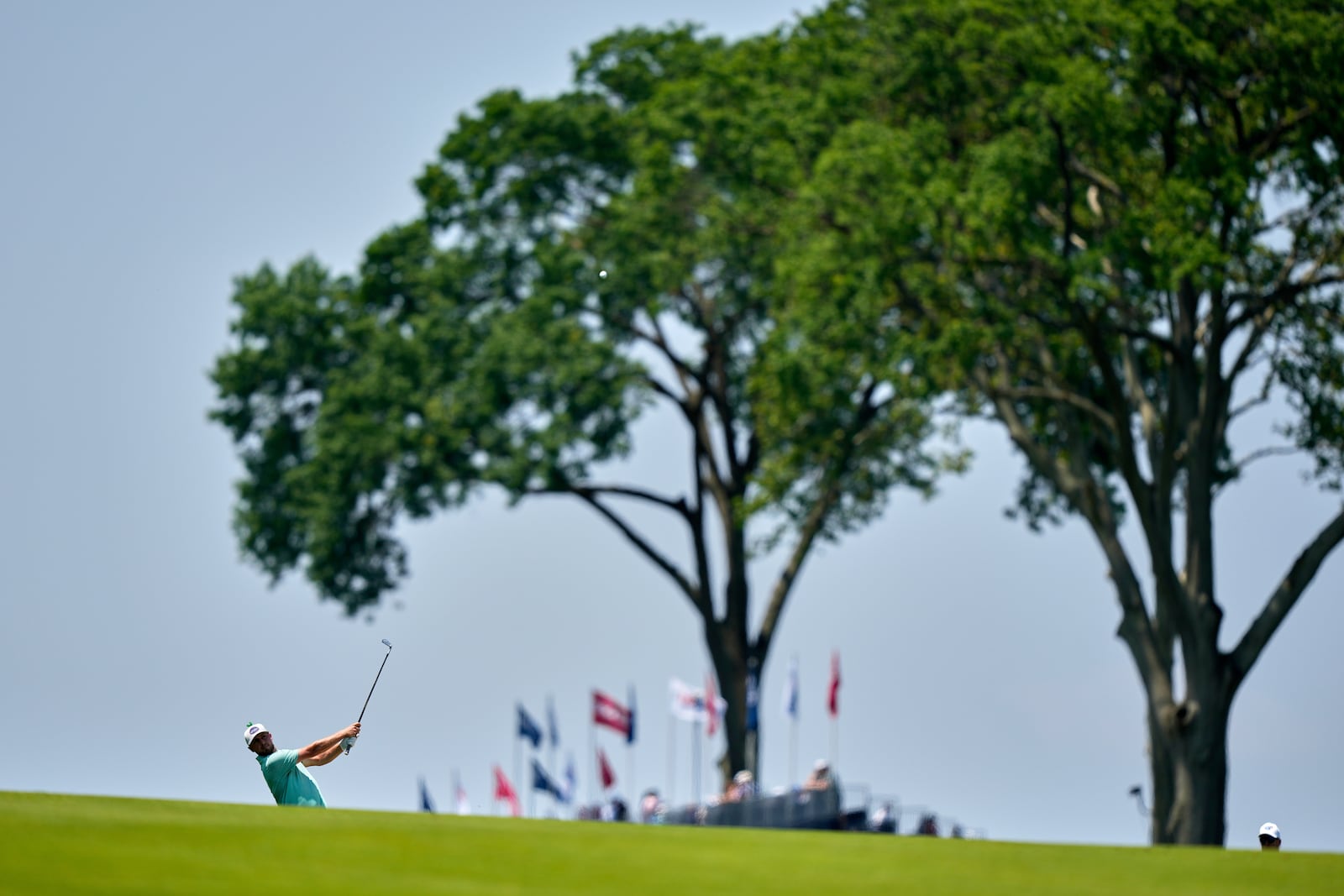 Alistair Docherty hits from the first fairway during a practice round ahead of the U.S. Open golf tournament at Oakmont Country Club Wednesday, June 11, 2025, in Oakmont, Pa. (AP Photo/Charlie Riedel)