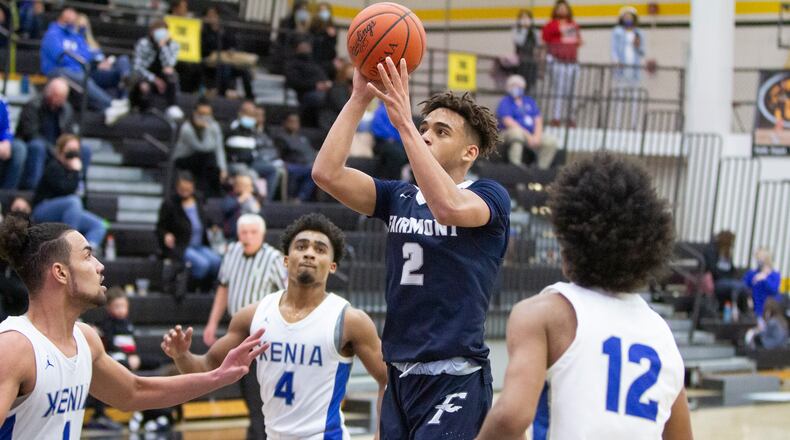 Fairmont's Dasan Doucet shoots while Xenia's Zack Gaither (1), Damien Weaver (12) and Dylan Hoosier (4) look on during Friday night's Division I sectional game at Centerville High School. Fairmont advanced with a 68-48 victory.  Jeff Gilbert/CONTRIBUTED